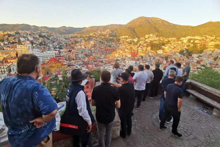 a group of people standing on top of a mountain